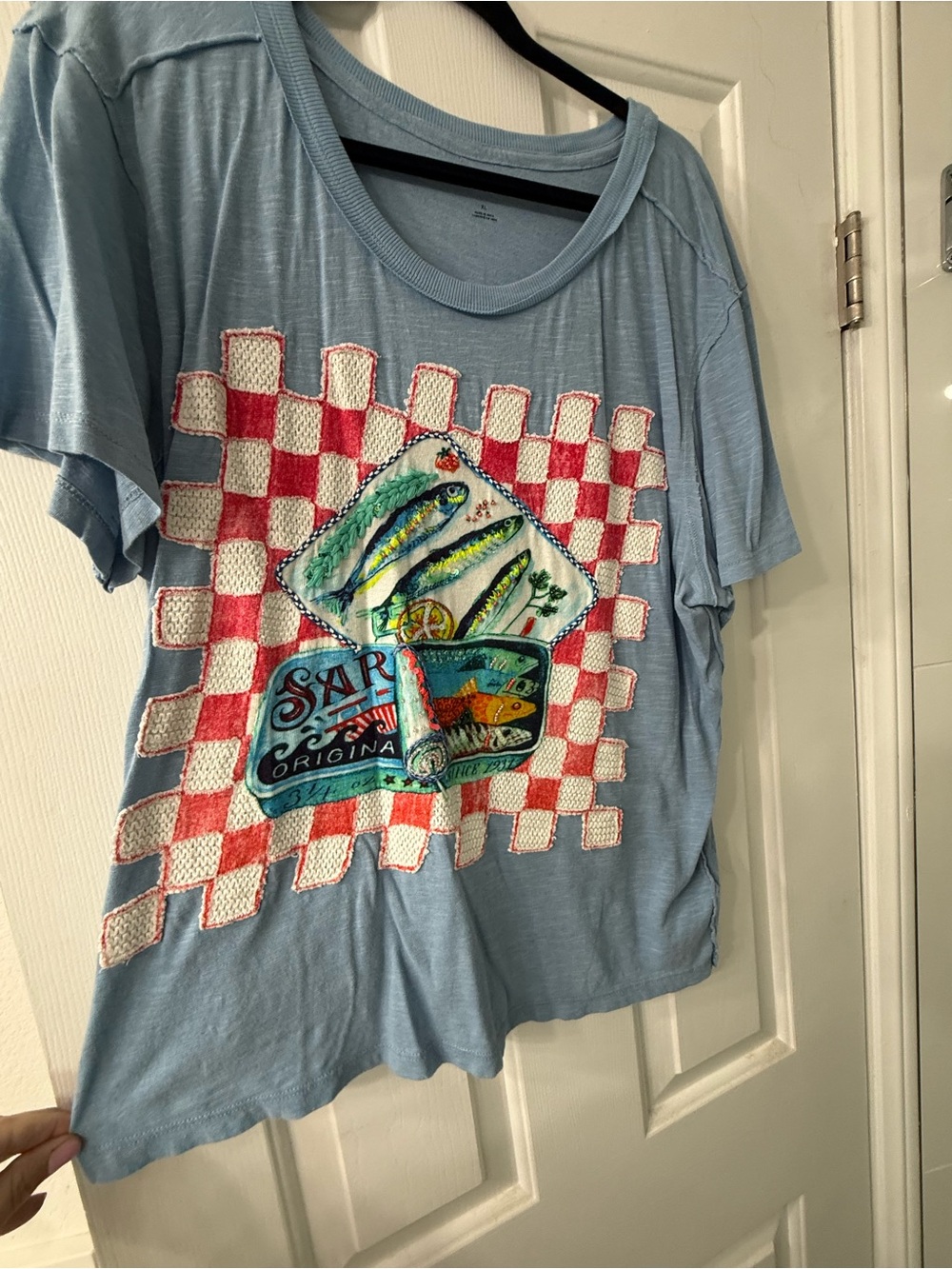 Anthropologie- Maeve Light Blue Graphic Tee with Sardine embellished in beads.